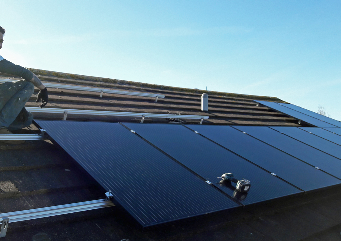 Solar panels being clamped to their rails (Image: T. Larkum)