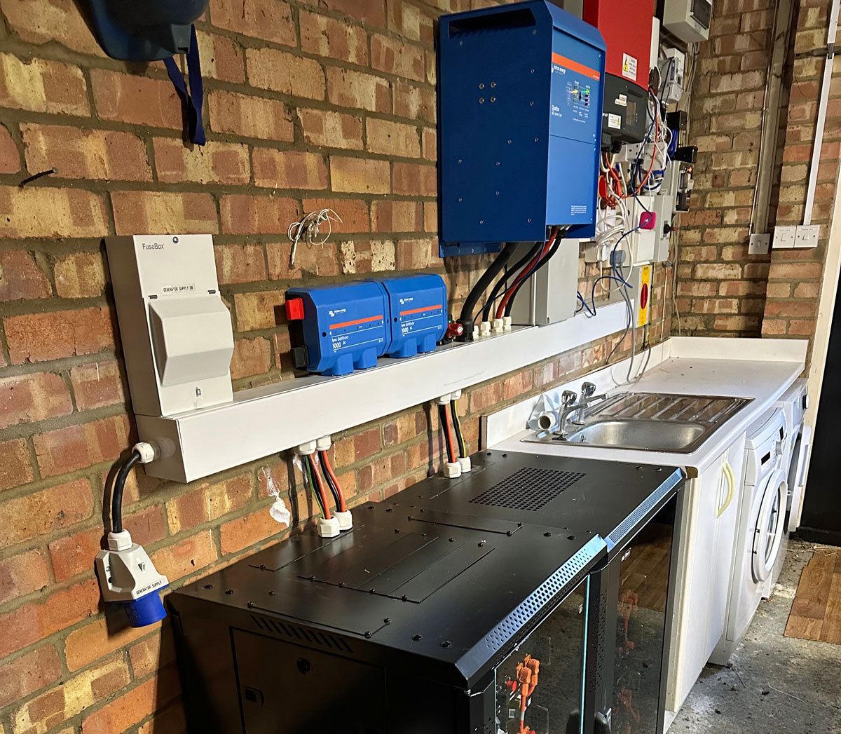 Upgraded Victron inverter, with batteries in cabinets below (Image: C. Brookson)